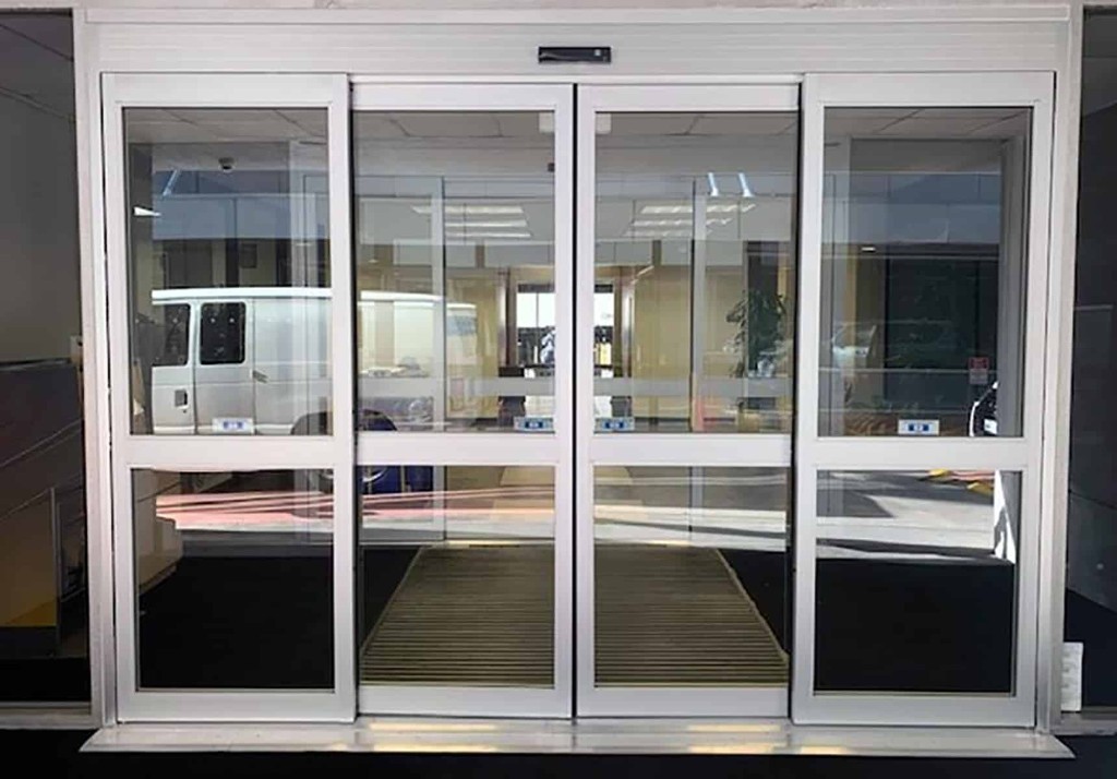 Automatic bi-part sliding door system installed at a commercial entrance