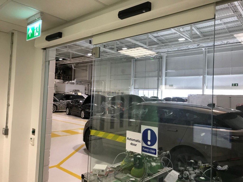 Single sliding toughened glass automatic door with side screen & header operator at Jaguar Land Rover in Coventry