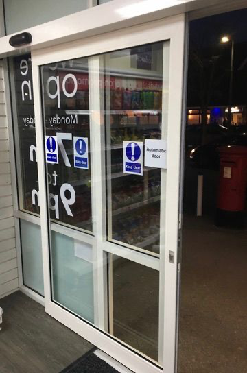 Label Evolus automatic single slide door with safety sensors at One Stop Convenience Store in Great Barr, Birmingham