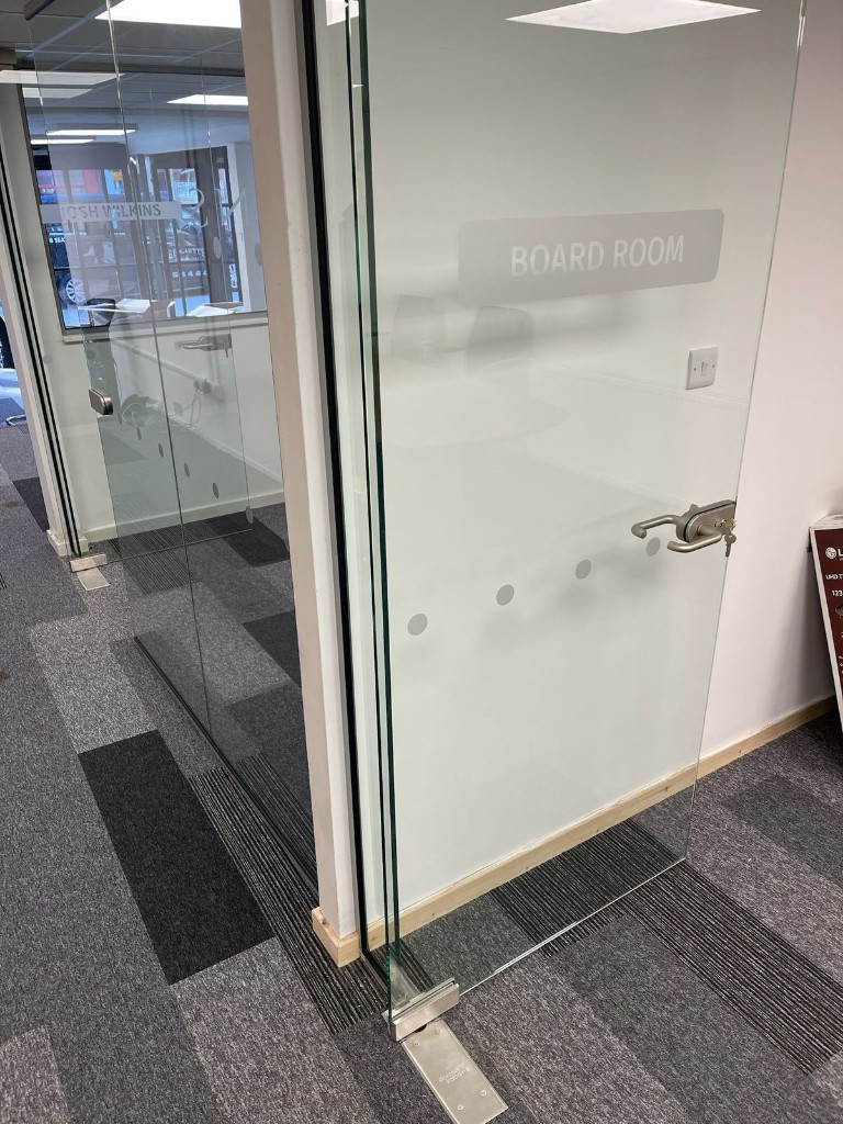 Frameless toughened glass door with floor spring, patch fittings & lever handle at Wilkins Estate Agents in Tamworth