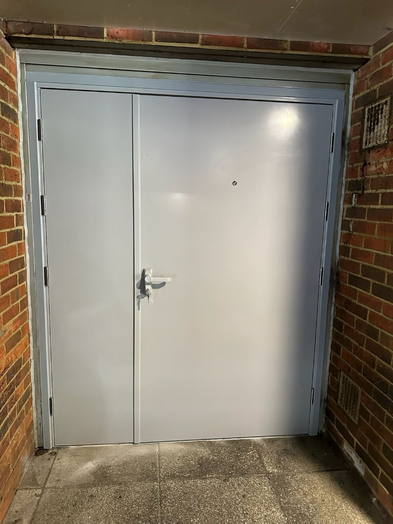 Double steel fire exit doors with lever handle & low-level threshold at Nando's in Basingstoke