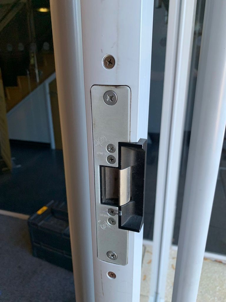 Adams Rite electric strike fitted in a commercial aluminium door frame during access control repair