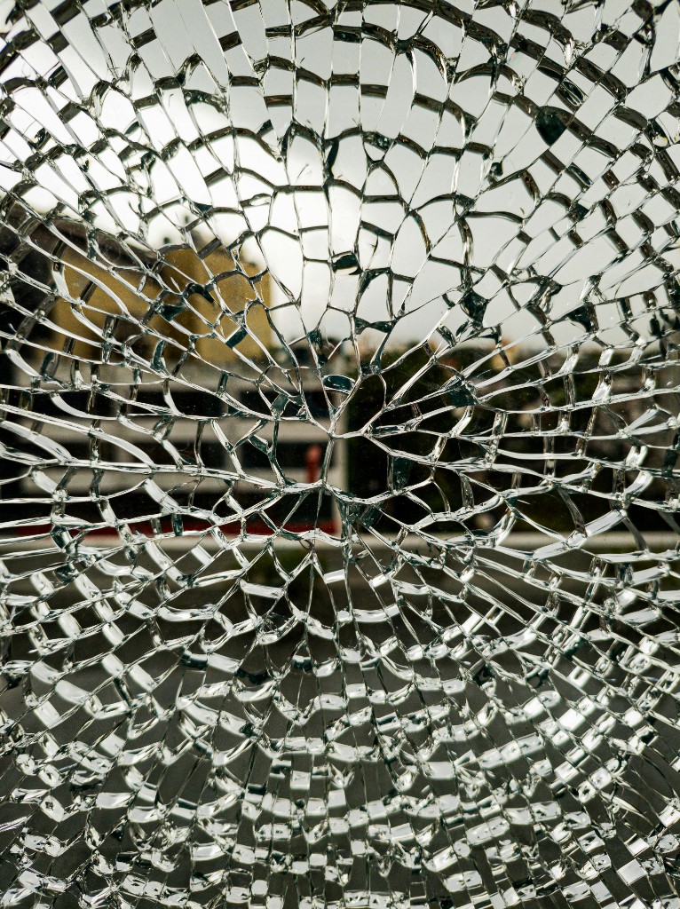 Smashed commercial door glass highlighting emergency damage risk