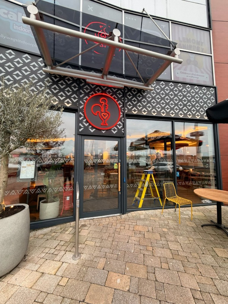 Aluminium Framed Glass Entrance At A Commercial Restaurant With Maintenance Works Visible Inside