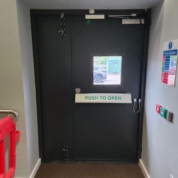 Steel fire exit double doors with panic bar, push to open signage & overhead door closers