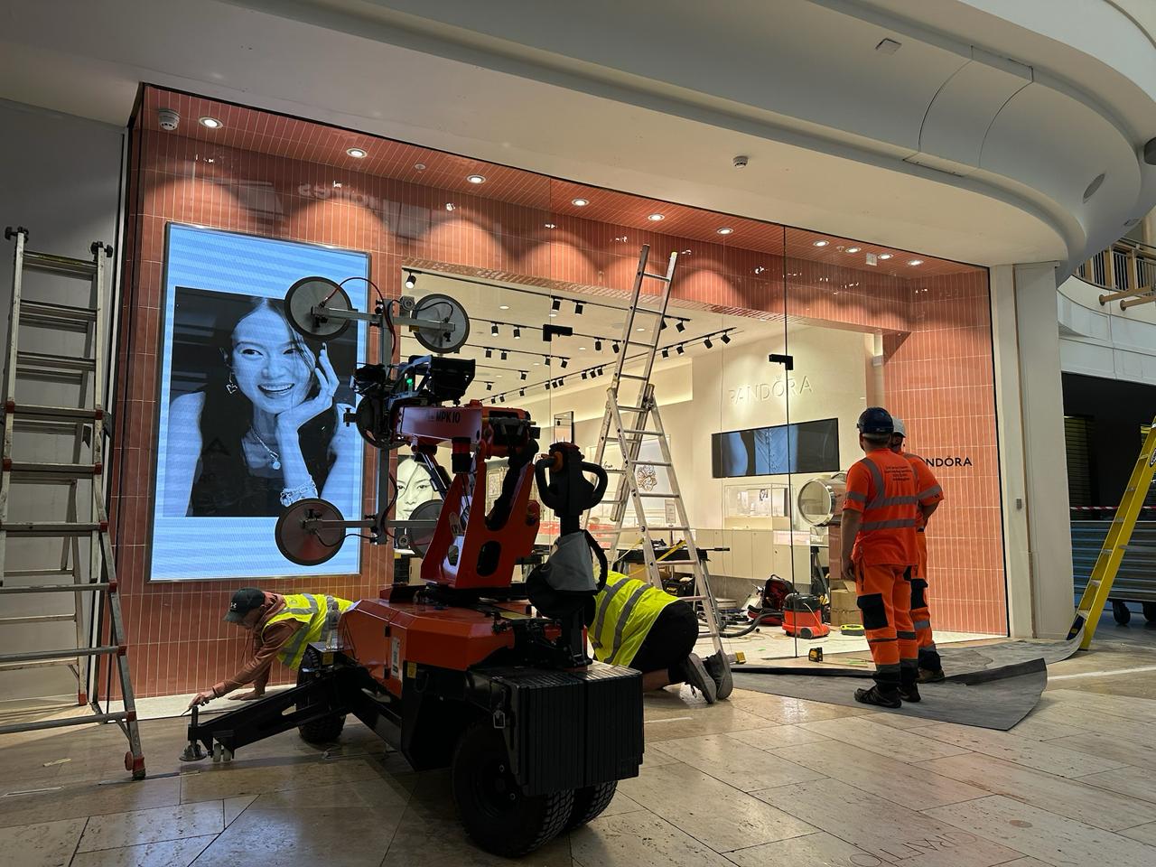 Frameless glass shopfront installation progressing on a commercial frontage