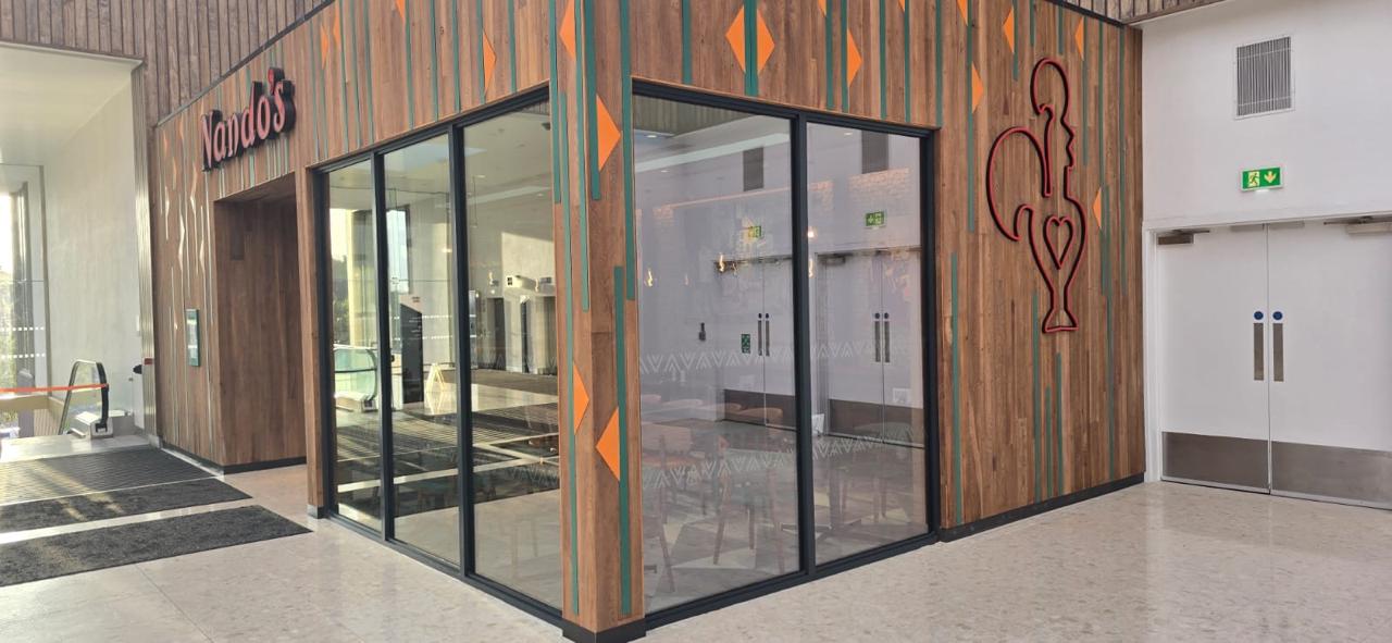 Thermal aluminium commercial shopfront installation on a live site